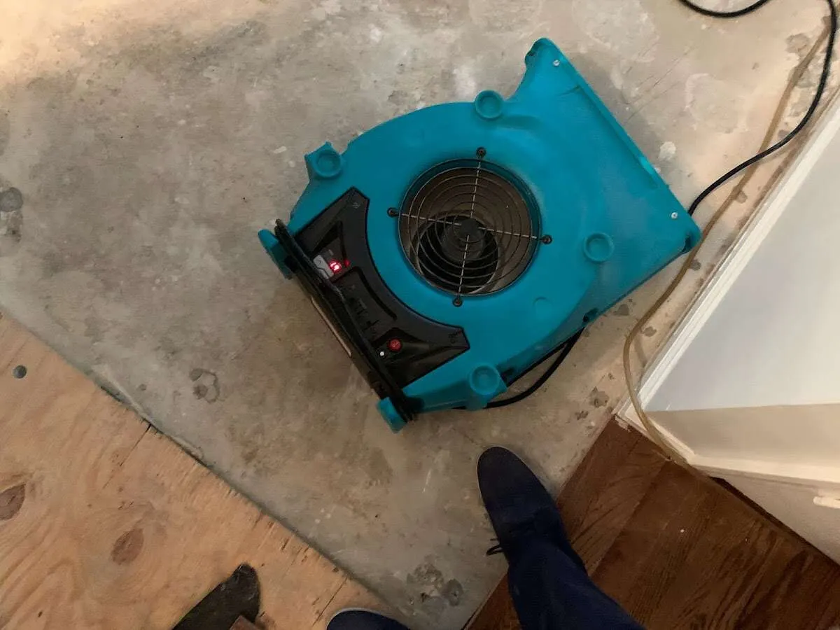Air mover drying subfloor during Commercial Water Damage Restoration in Oceanport